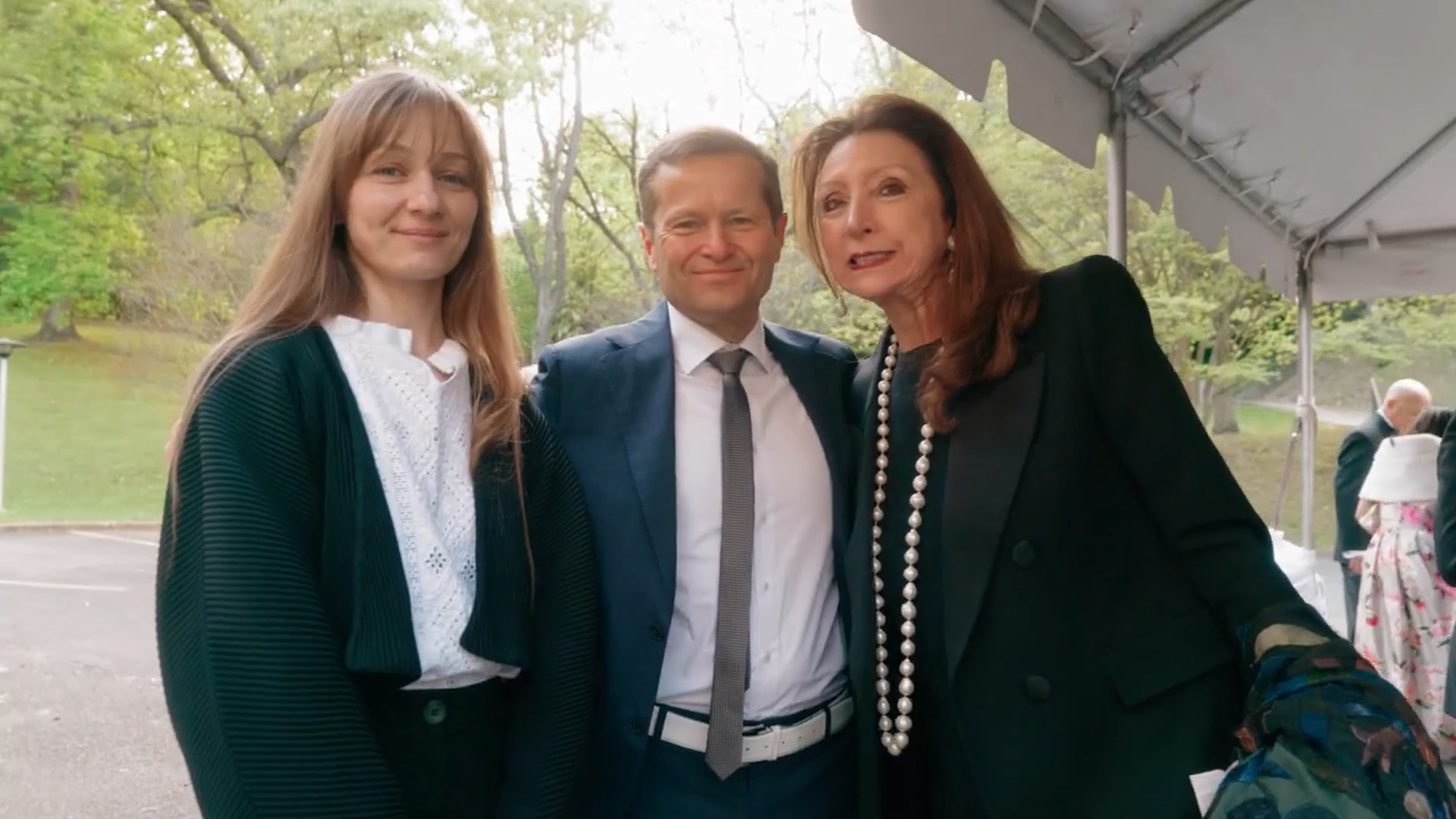 Guests in formal attire under the reception tent