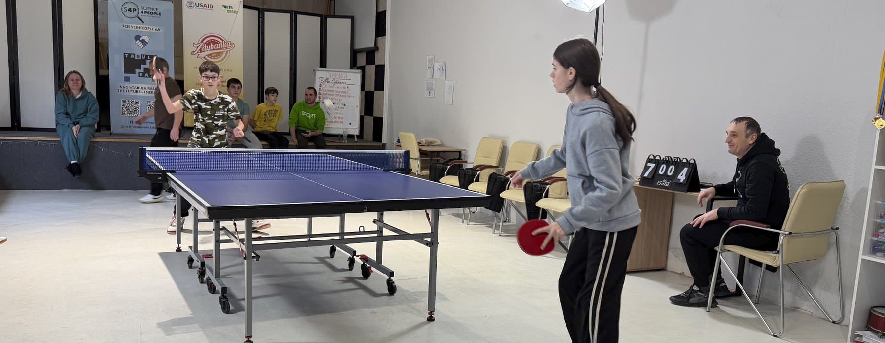 Youth playing a competitive match with scoreboard